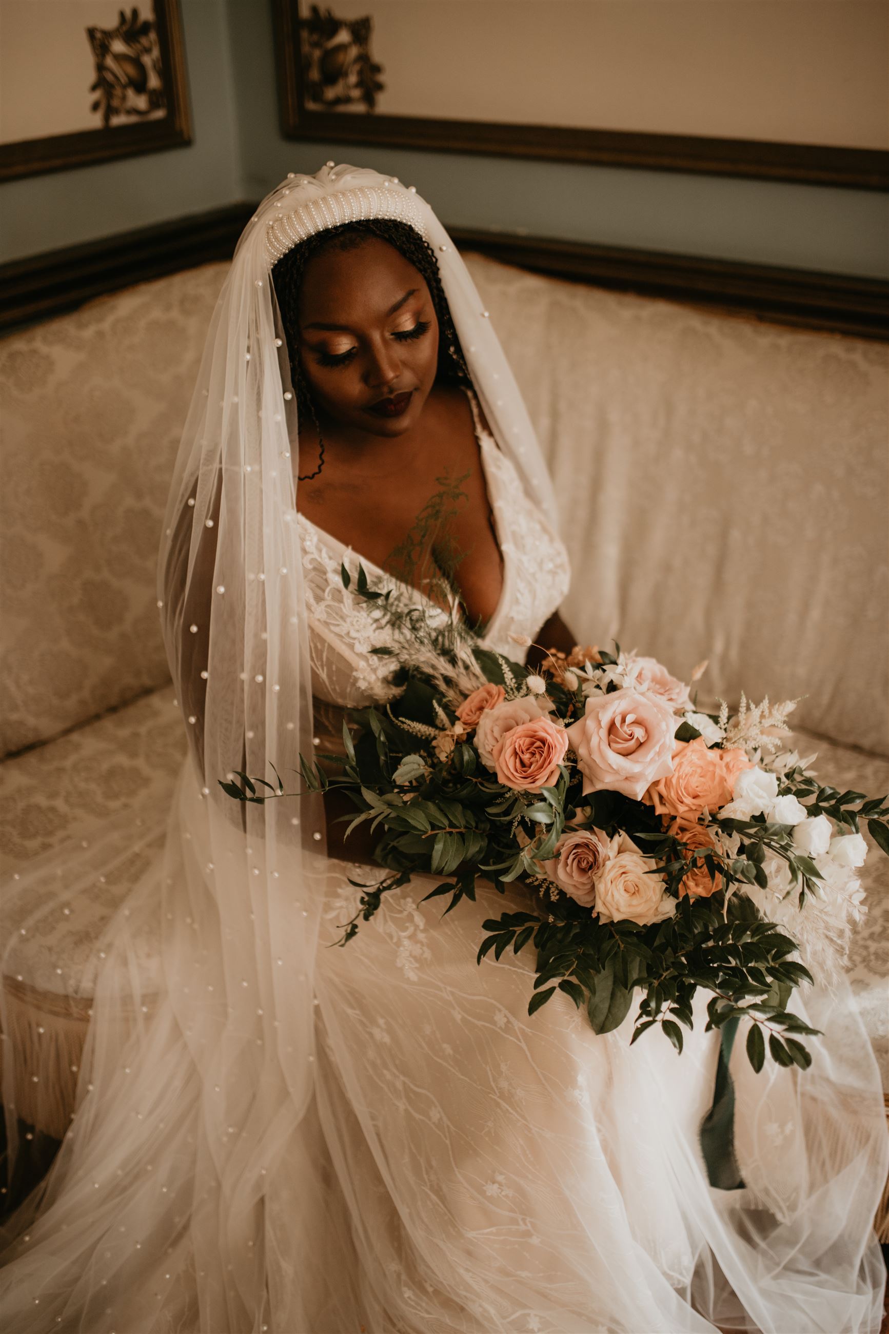 Bride wearing Martin Thornburg and holding her floral bouquet