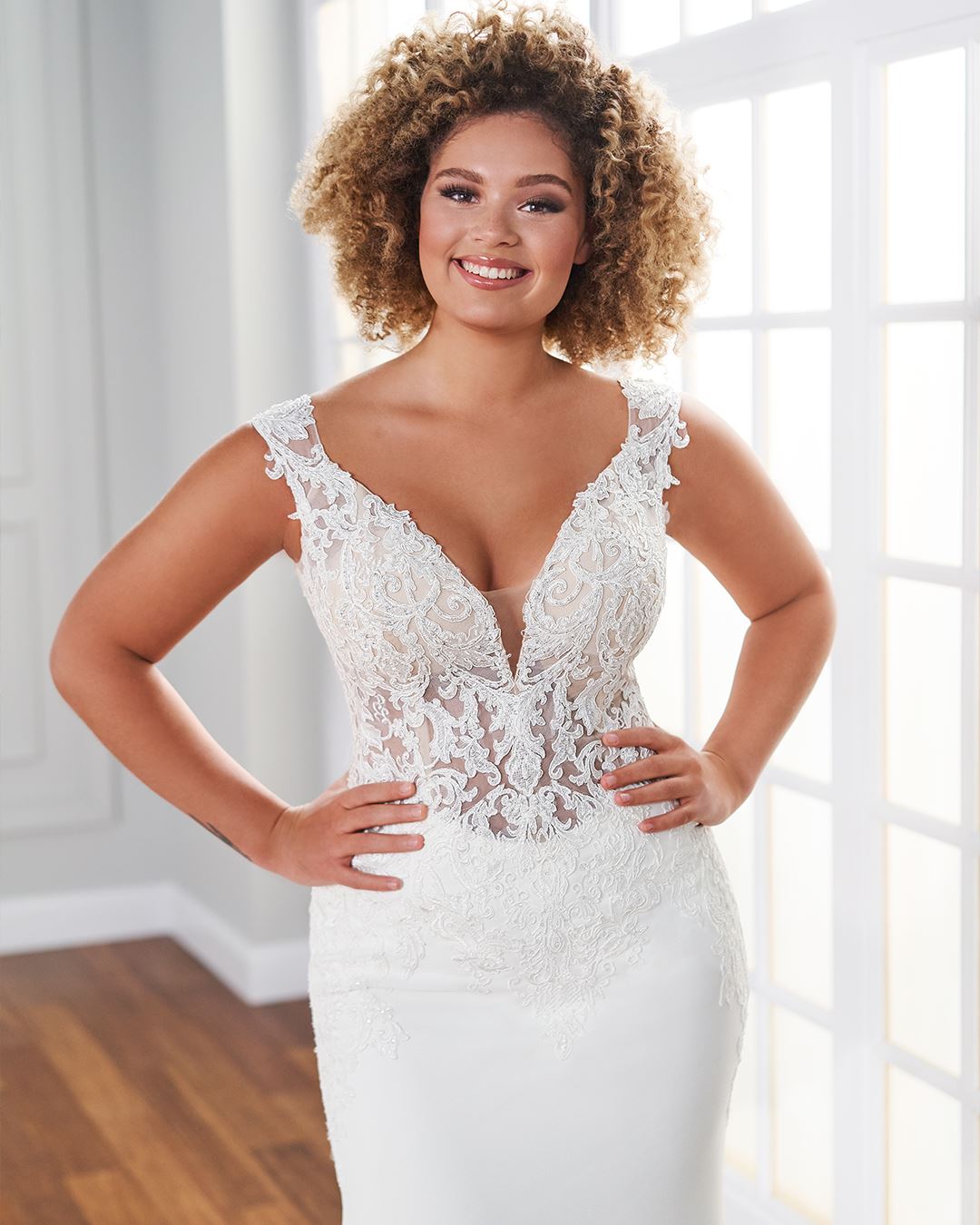 Bride wearing fit and flare wedding dress with lace bodice