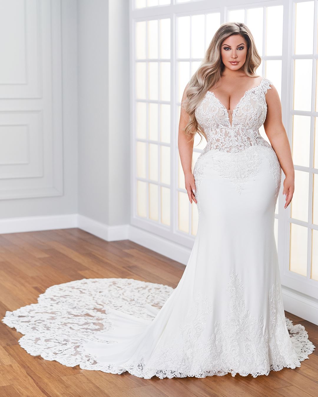 Bride wearing fit and flare wedding dress with cap sleeves
