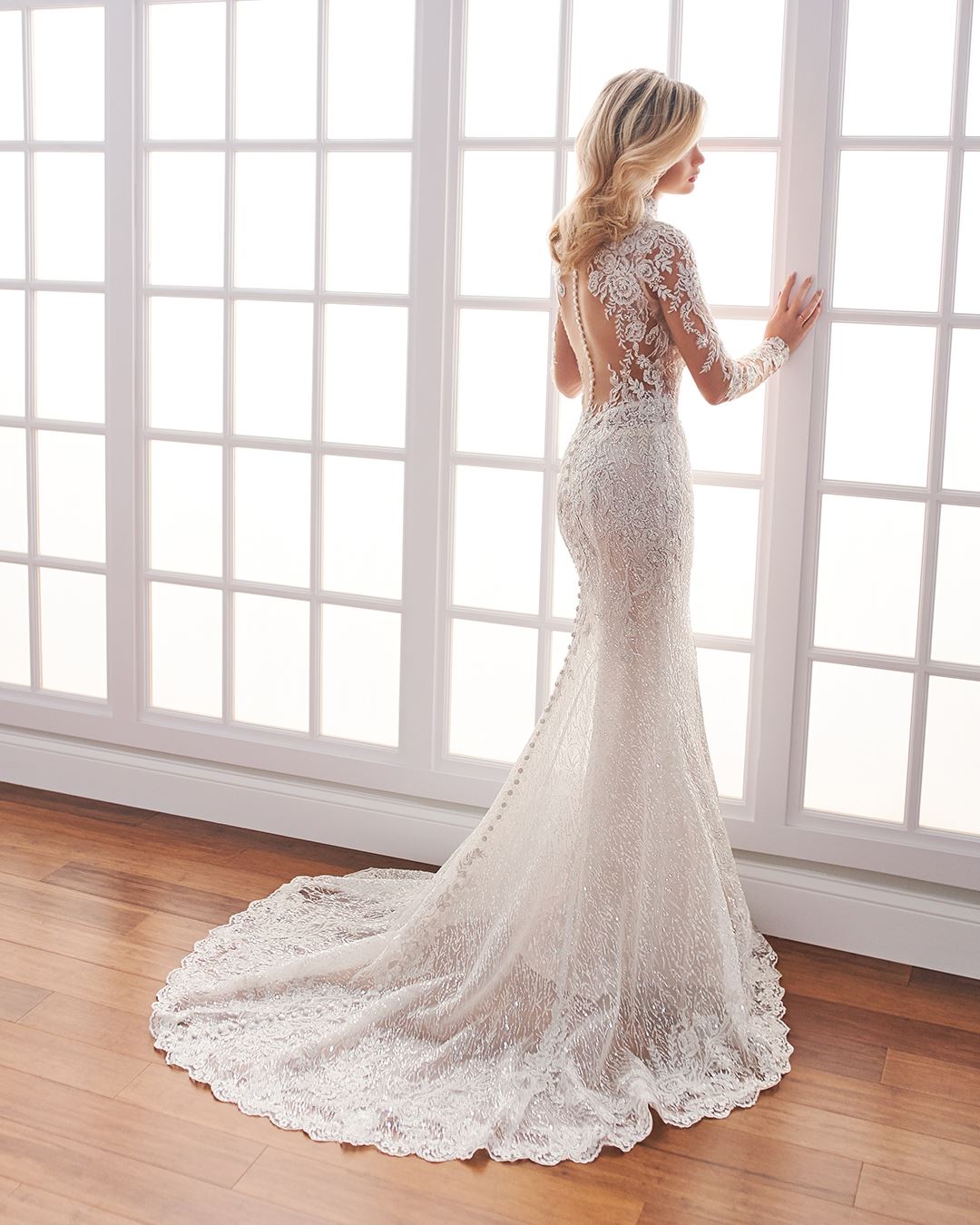 Bride wearing long sleeve wedding dress with sheer lace back